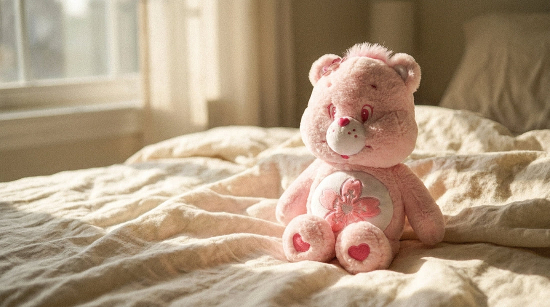 Pink Sakura Care Bear plush on cream linen in morning light